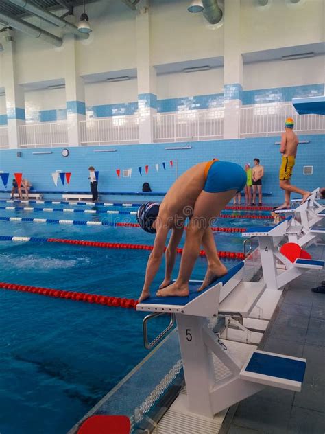 Training Swimmers. a Teenage Boy is Preparing To Jump into the Pool ...