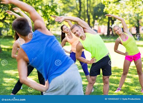 Group of Happy People Exercising at Summer Park Stock Image - Image of ...