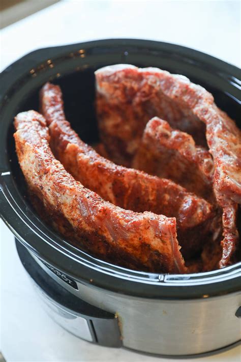 several pieces of cooked meat in a crock pot on a counter top, ready to ...