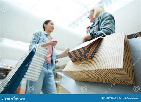 Colorful Paper Shopping Bags in Hands of Customers Stock Photo - Image ...