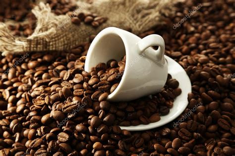 Cup with coffee beans, close up Stock Photo by ©belchonock 21922437