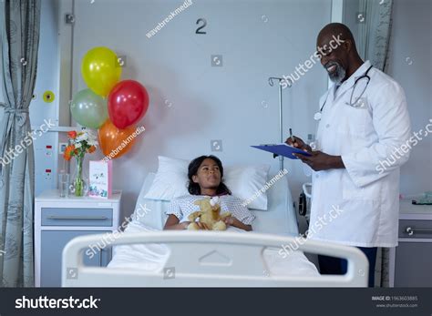 Smiling African American Male Doctor Writing Stock Photo 1963603885 ...