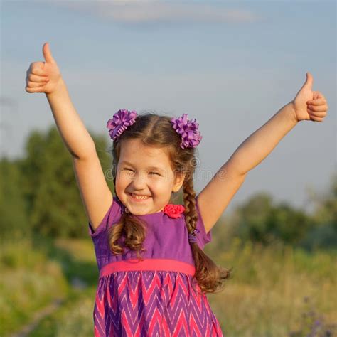 Child Showing Thumbs Up Outdoors Stock Photo - Image of finger, grass ...