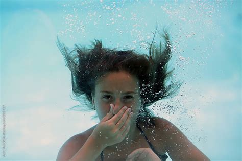 A Girl Holding Her Breath While Swimming Underwater by ALICIA BOCK ...