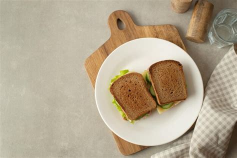 Premium Photo | Sandwich with mortadella cheese and tomatoes on a gray table