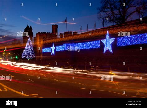 Cardiff Castle at night with Christmas lights / decorations and traffic trails in foreground ...