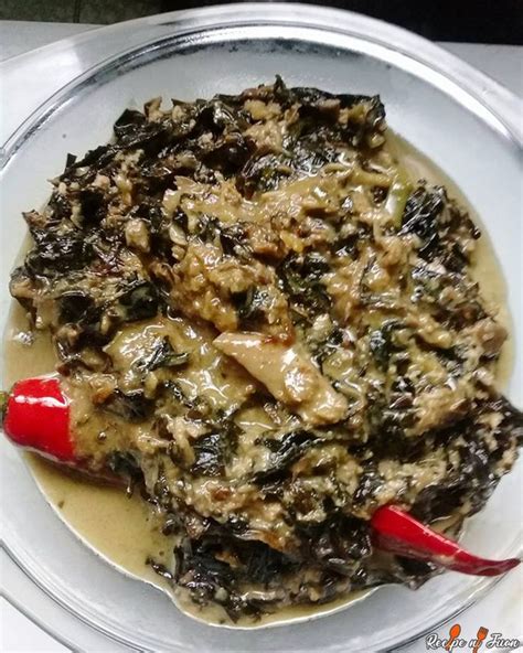 a white bowl filled with food on top of a table