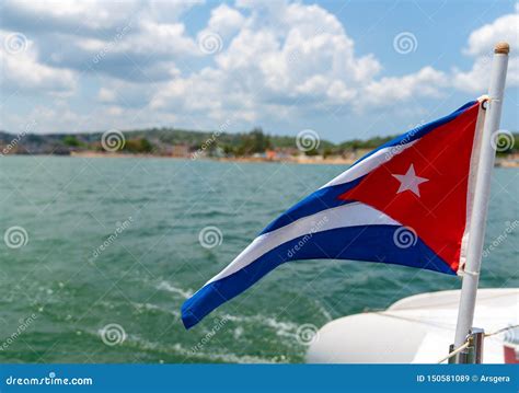 Cuba Flag Waving on Boat at Sea Near Cuban Coastline Stock Image ...