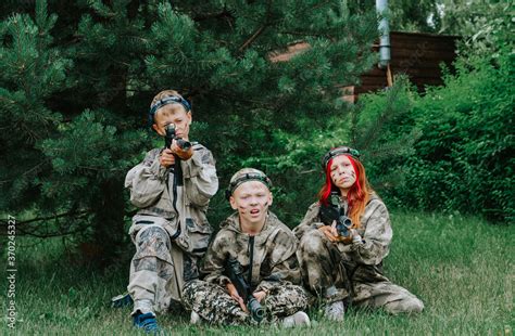 Children playing in lasertag shooting game, boy with a gun, war ...