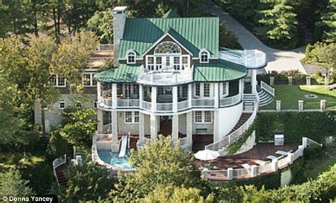 an aerial view of a large house surrounded by trees