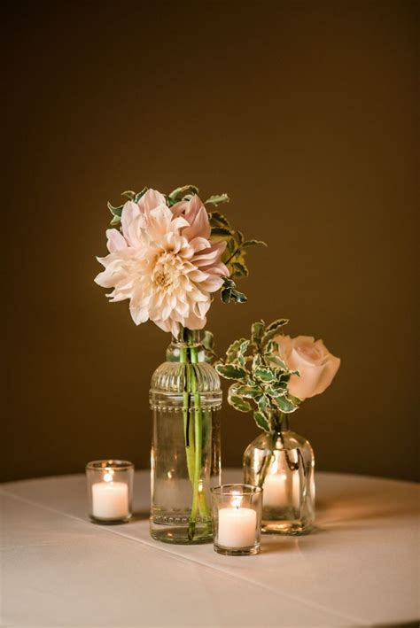 Vintage clear glass bud vases with blush dahlias, roses, and greenery ...