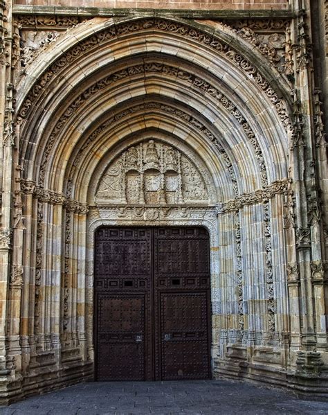 an old building with two large wooden doors