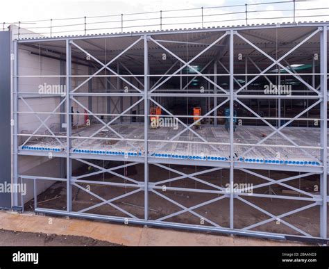 Construction process of a warehouse during daytime Stock Photo - Alamy