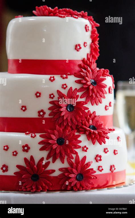 Wedding cake with red flowers Stock Photo - Alamy