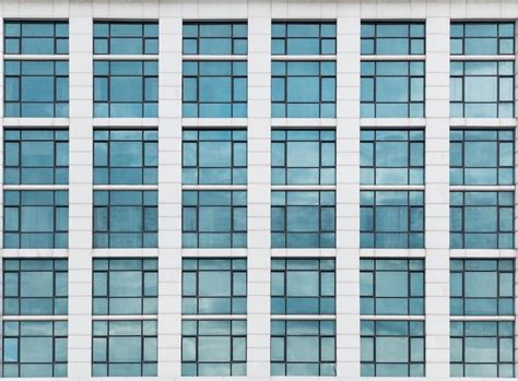 Premium Photo | The glass window pattern on the building wall with the cloud reflection