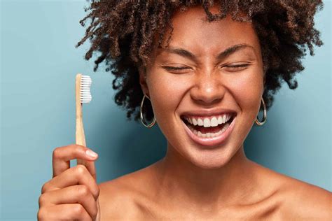 Dental health concept. Happy smiling dark skinned woman with curly hair ...