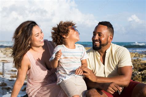 Laughing family sitting on beach Stock Photo | Adobe Stock