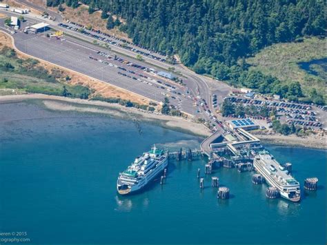 an aerial view of boats docked at a pier in the water next to a road