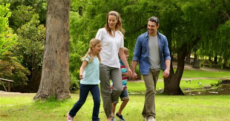 Happy Family Walking In The Park Together On A Sunny Day Stock Footage Video 5380754 - Shutterstock