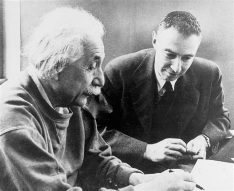 Albert Einstein: Albert Einstein sits with fellow physicist J. Robert Oppenheimer who followed ...