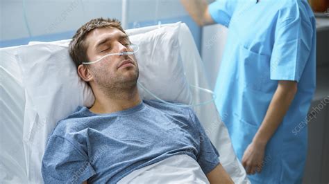 Sick patient sleeping in a hospital bed - Stock Image - F033/3163 - Science Photo Library