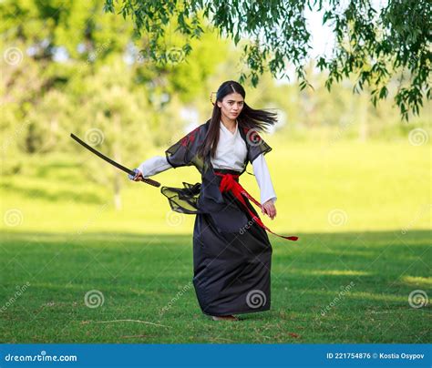 Young Asian Woman in Traditional Kimono Trains Fighting Techniques with ...