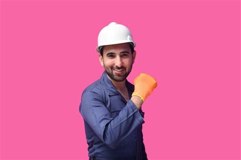 Premium Photo | Young construction worker wearing blue shirt posing over pink background indian ...