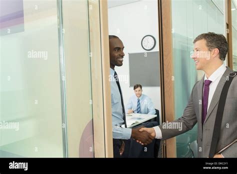 Businessmen shaking hands in office Stock Photo, Royalty Free Image ...