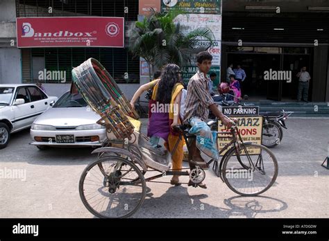 A woman getting out of a rickshaw at the Banani shopping center in Dhaka Bangladesh Stock Photo ...