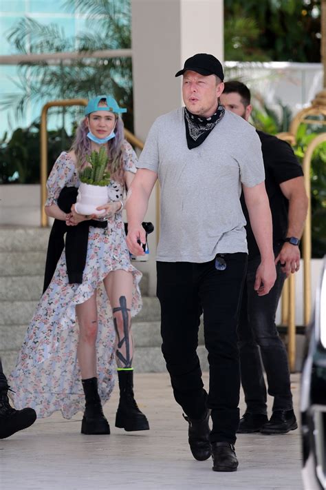 Elon Musk carries baby son 'X Æ A-12' as billionaire dad leaves Miami hotel with Grimes ahead of ...