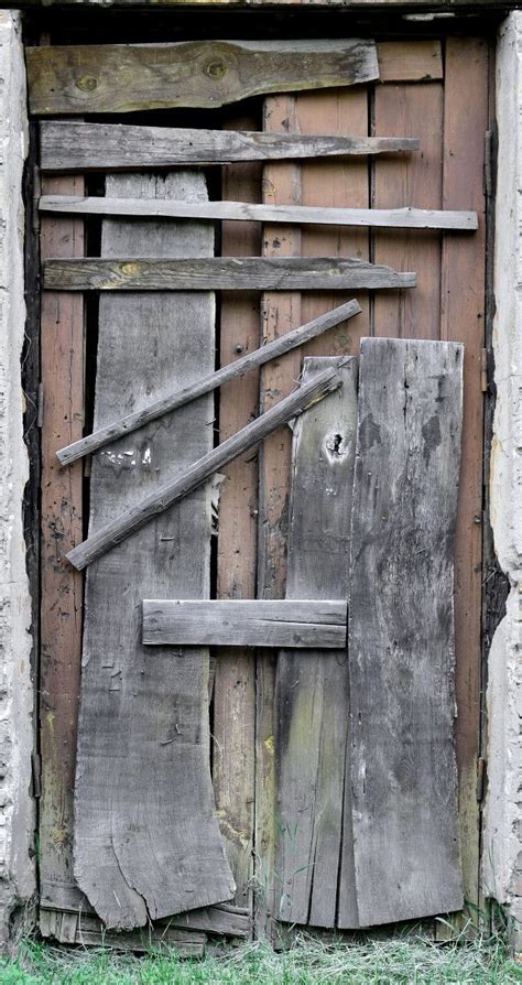 Premium Photo | Boarded up wooden door to an old abandoned house | Wooden doors, Old wooden ...