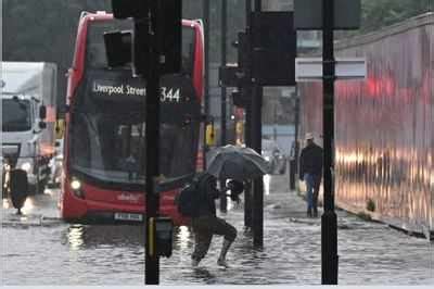 London Flood: London cleans up after flash flooding drenches homes ...