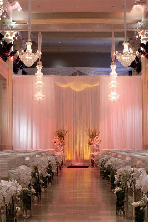 The couple's ceremony space was decorated with elegant drapery ...