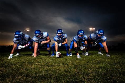 Football Players In Blue Jersey Lined Under Grey White Cloudy Sky ...