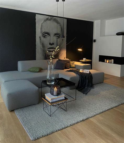a living room with a large painting on the wall next to a couch and ...