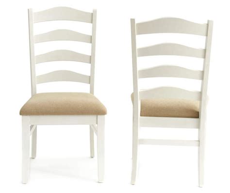 two white chairs side by side, one with a tan seat and the other without