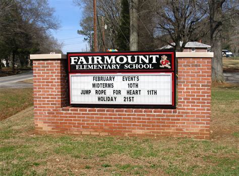 a sign for the fairmount elementary school in front of a brick wall and ...