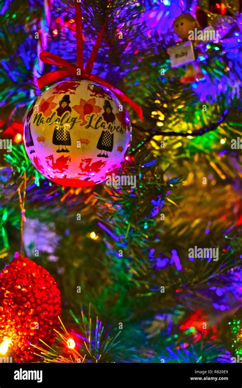 Brightly coloured Christmas tree decorations,one with a Welsh Lady in ...