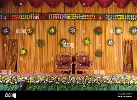 India wedding reception stage with two chairs and flower decorations Stock Photo - Alamy