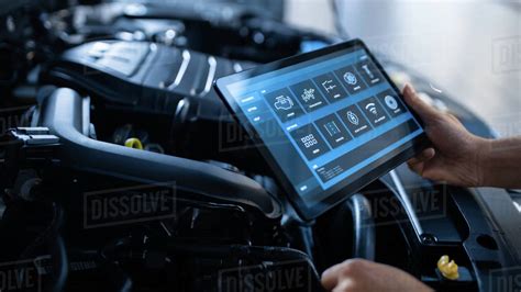 Car Service Manager or Mechanic Uses a Tablet Computer with a ...