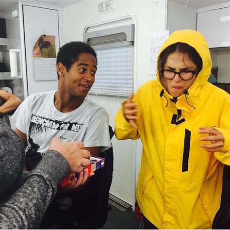 Two People in Yellow Raincoats Talking