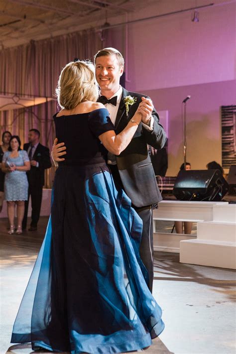 Smiling Groom Dancing with Mother