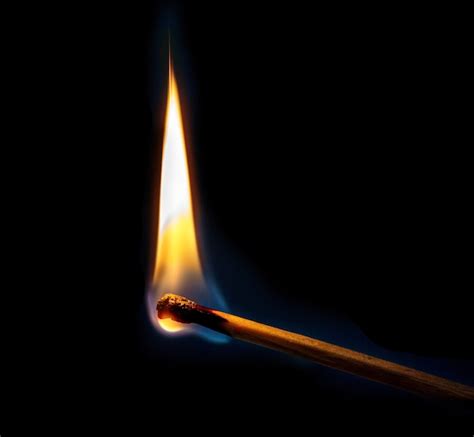 Premium Photo | Burning match with fire on a black background. ignition of a match. fire on a match.