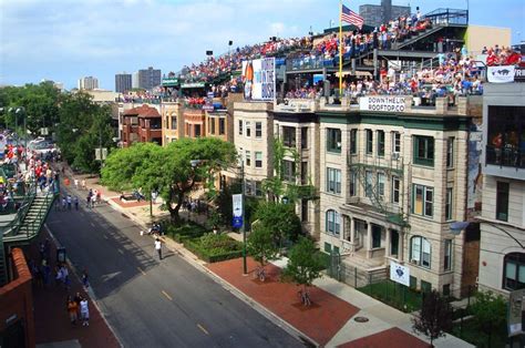 a crowd of people are sitting on the roof of buildings and watching a ...