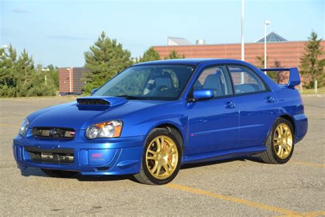 Blue subaru Impreza WRX sti with gold rims - 9GAG