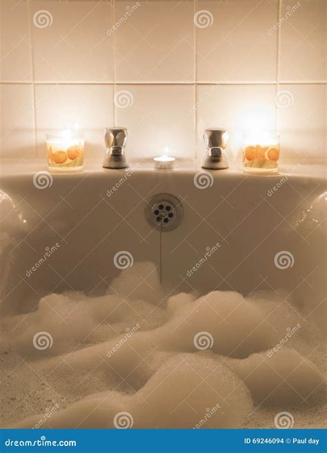 Bubble bath and candles stock photo. Image of bating - 69246094