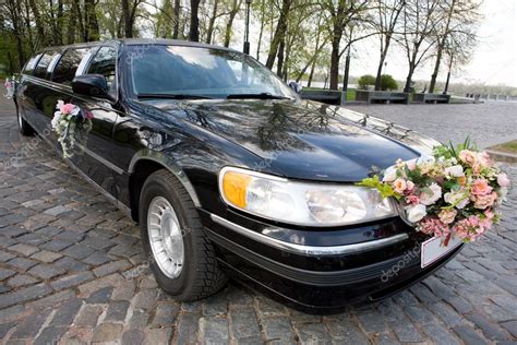 Black Wedding Limousine. Ornated with flowers. – Stock Editorial Photo © edfoto #4452200