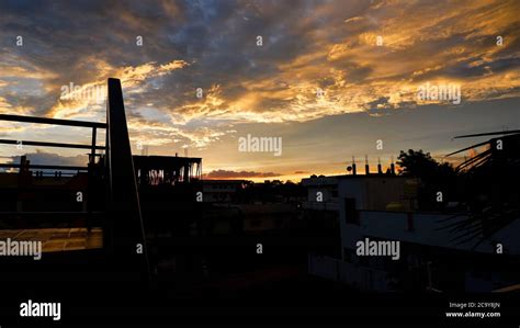 a colorful evening sunset in town buildings silhouette Stock Photo - Alamy