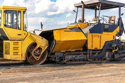 Premium Photo | Asphalt paving equipment. Asphalt paver and heavy vibratory roller.