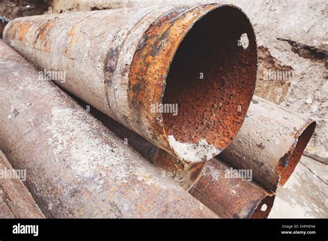 Fragments of old large water pipes. After many years of operation, corroded metal pipe destroyed ...